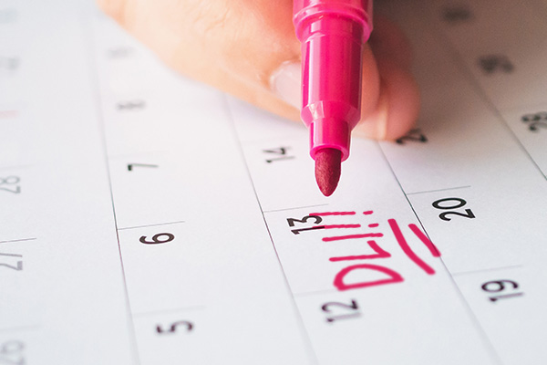 A person marking in red pen the Date Last Insured on a calendar for their SSD benefits.